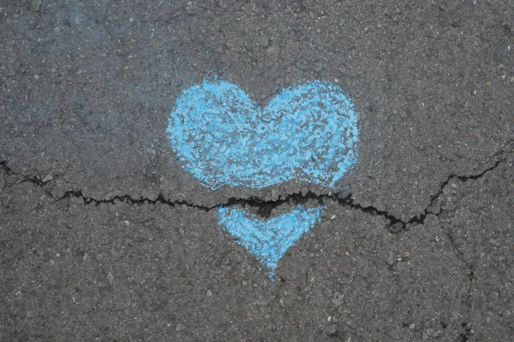 top-view-broken-chalk-heart-asphalt
